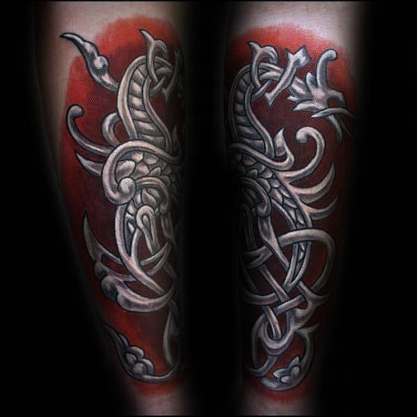 Red and white ink Celtic dragon forearm tattoo