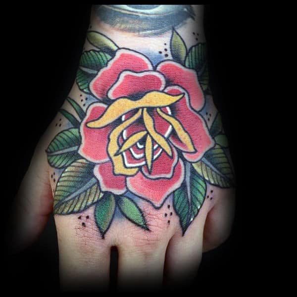 Red And Yellow Traditional Rose Hand Tattoo On Man
