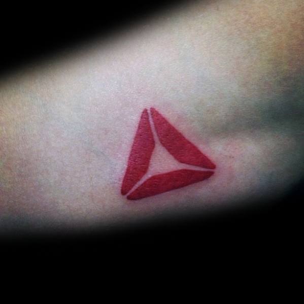 Minimalist red Reebok CrossFit logo tattoo on the forearm, symbolizing dedication to fitness, strength, and the CrossFit community.