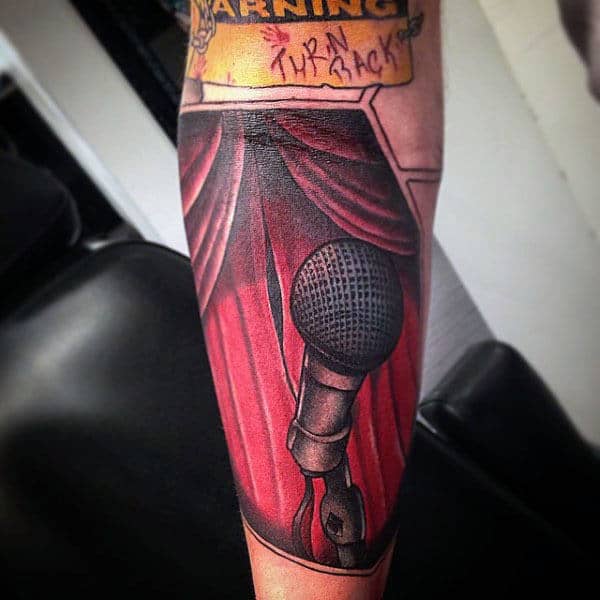 Red Curtained Dias And Microphone Tattoo Male Forearms