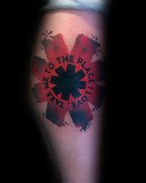 Tattoo featuring the Red Hot Chili Peppers logo with a distressed red paint effect and the lyrics "Take me to the place I love" circling it.