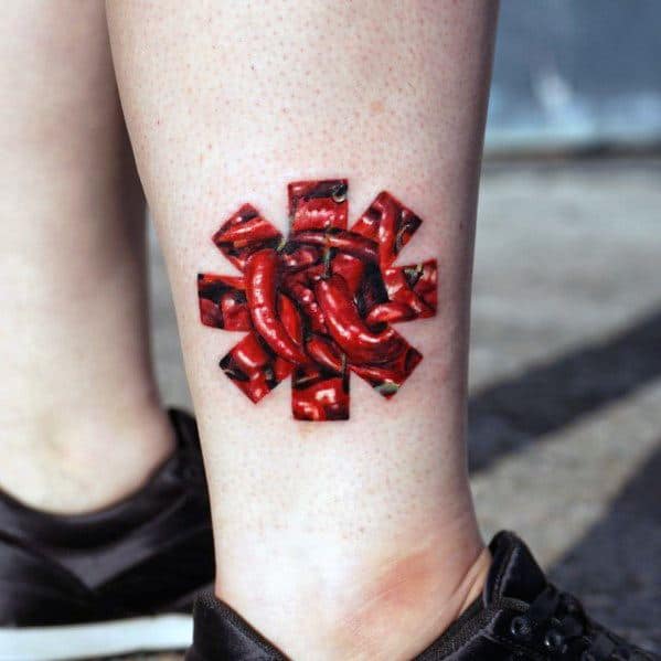 Ankle tattoo featuring the Red Hot Chili Peppers logo filled with realistic red chili peppers, creating a bold and creative tribute design.