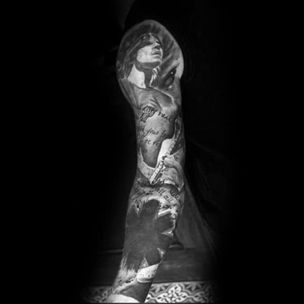 Black and grey full sleeve tattoo featuring a detailed portrait, handwritten script, and the Red Hot Chili Peppers logo for a bold artistic look.