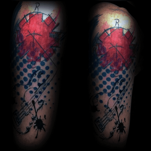 Tattoo featuring the Red Hot Chili Peppers logo with abstract splashes, a sketched bass guitar, and blue dot patterns for a bold artistic look.