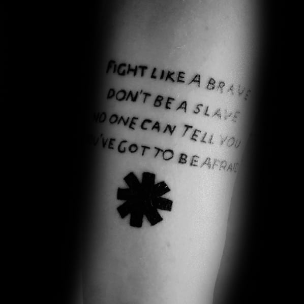 Tattoo featuring lyrics from *Fight Like a Brave* in bold black text, with the Red Hot Chili Peppers logo below for a powerful tribute design.