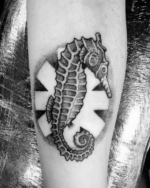 Tattoo featuring a detailed black and grey seahorse over the Red Hot Chili Peppers logo, with dotwork shading for a unique and artistic design.