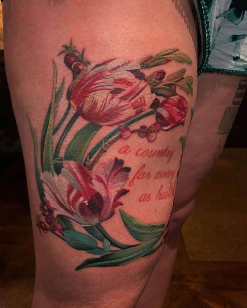 A vibrant and detailed tulip tattoo on the thigh, featuring rich red and pink flowers, green leaves, and a quote that reads "a country far away as hearts."