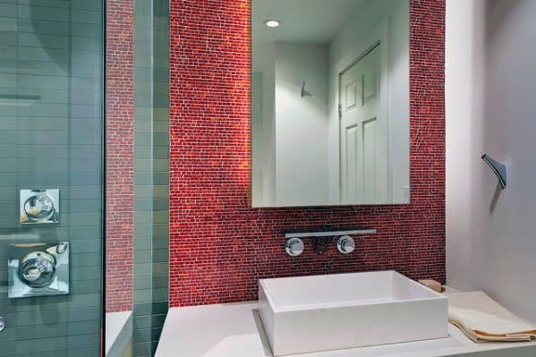 Bathroom with red mosaic tile backsplash, square sink, and modern wall-mounted faucet.
