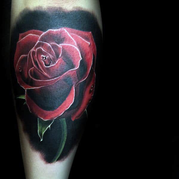 Tattoo of a realistic red rose with green leaves