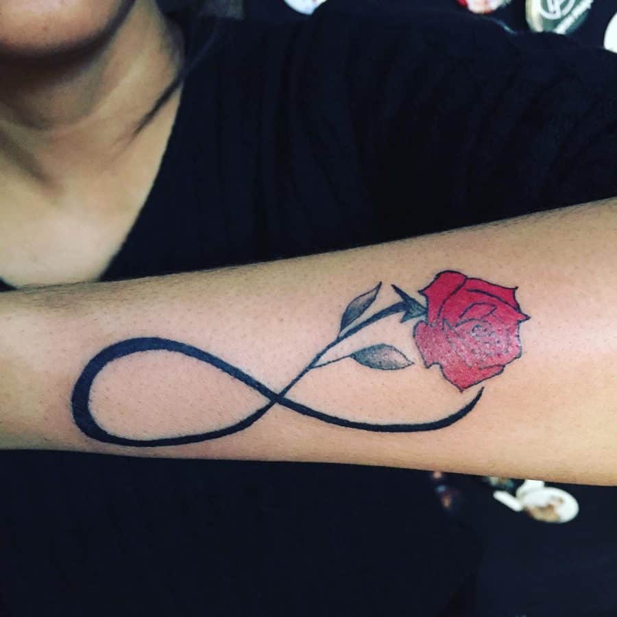 A beautiful infinity tattoo with a red rose and delicate leaves, symbolizing eternal love and beauty.