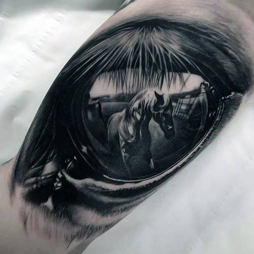 Tattoo of a horse’s eye reflecting a stable scene, capturing intricate details and realism for a powerful and emotional equine-inspired design.