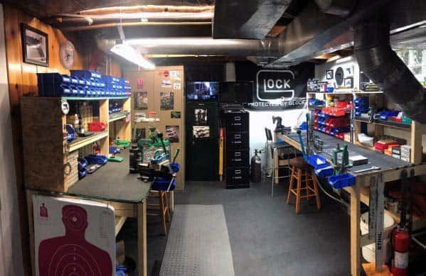 Spacious reloading room with multiple workbenches, mounted presses, organized storage bins, and a professional setup ideal for reloading and precision work