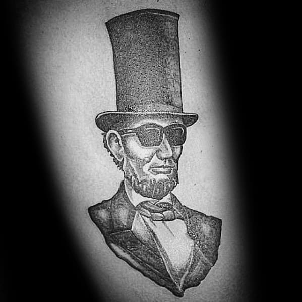 Tattoo of a man in a top hat and sunglasses, resembling Abraham Lincoln's vintage style