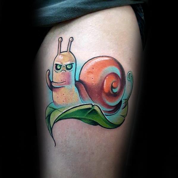 Adventure Time tattoo of the show's recurring snail character with an intense expression, sitting on a leaf, inked on the upper thigh.