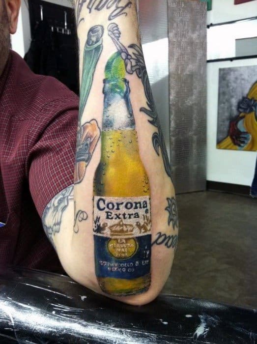 Hyper-realistic color tattoo of a Corona Extra beer bottle with a lime wedge, placed on the forearm and detailed with reflections and texture for a lifelike effect.