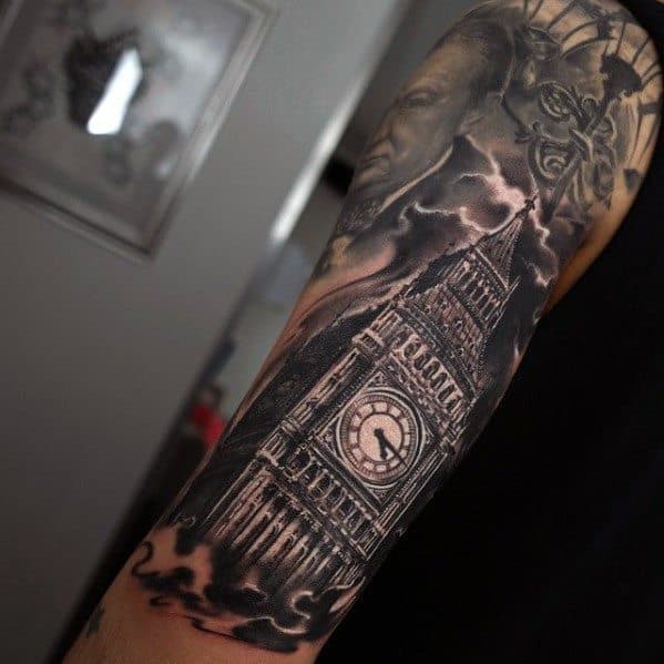 Detailed black and grey tattoo of Big Ben with dramatic cloud shading surrounding the clock tower, showcasing intricate architectural and shading details on the forearm.