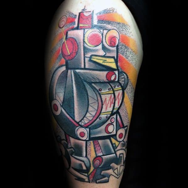 Colorful Cubist-style tattoo of a retro robot on the upper arm, with bold geometric shapes, red accents, and orange-yellow rays in the background.