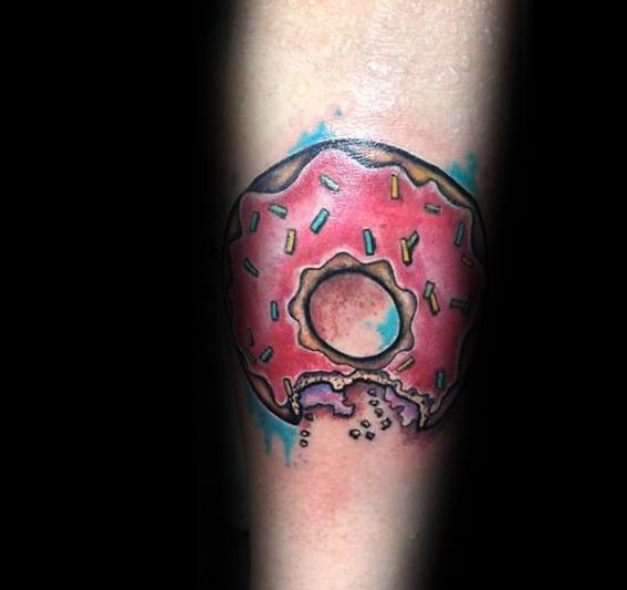 Tattoo of a bitten pink frosted donut with colorful sprinkles, crumbs falling below, and a teal watercolor-style background.