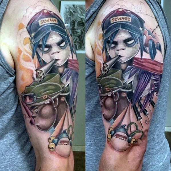 Full-color upper arm tattoo of Noodle from Gorillaz wearing a "Sewage" cap, smoking, with layered elements like military gear and a monkey toy.