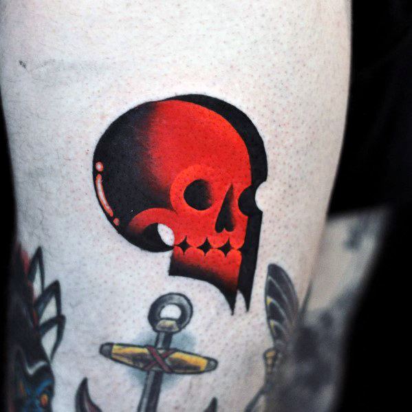 Stylized skull tattoo with a bold black and red gradient, featuring sharp lines and high contrast for a modern, graphic look.