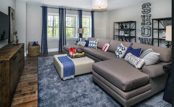 Comfortable living room with large sectional sofa and blue decor accents.