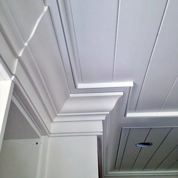 Stunning crown molding design with shiplap ceiling, featuring clean lines and smooth white finish, enhancing the room's architectural style