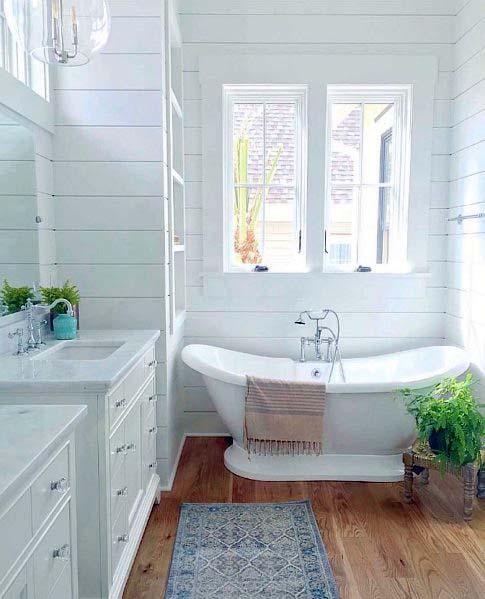shiplap and wood interior in modern bathroom with freestanding tub
