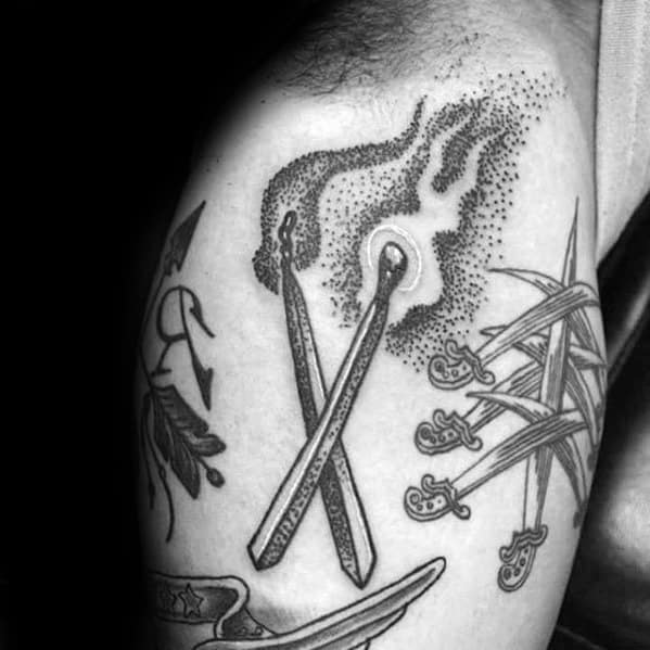 Dotwork tattoo of two crossed matchsticks with smoke and spark detail, symbolizing unity, ignition, or a powerful shared beginning.