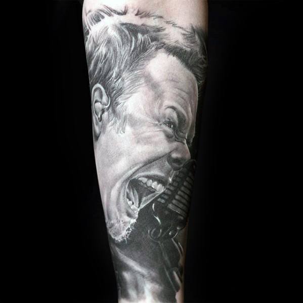 Hyper-realistic black and grey tattoo of James Hetfield screaming into a microphone, capturing raw stage energy and emotion.