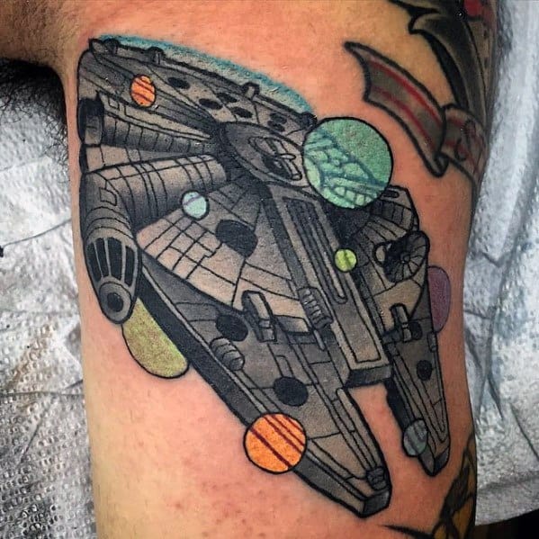 Bold Millennium Falcon tattoo with colorful planets floating around the ship, blending classic Star Wars design with playful cosmic elements.