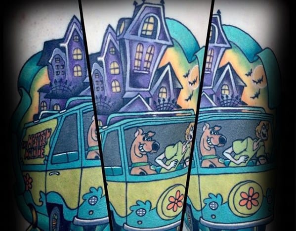 Tattoo of the Mystery Machine with Scooby-Doo and the gang driving past spooky purple haunted houses under a glowing night sky.