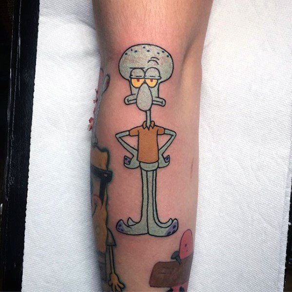 Clean and colorful Squidward tattoo with arms crossed and a bored expression, standing upright in his classic brown shirt and purple shoes.