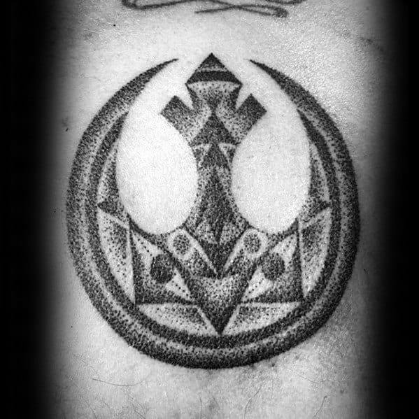 Black and white tattoo featuring a geometric Rebel Alliance symbol from Star Wars