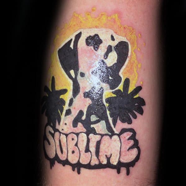 Tattoo of Sublime’s iconic Dalmatian with black palm trees and bold “SUBLIME” lettering, set against a yellow splatter background.