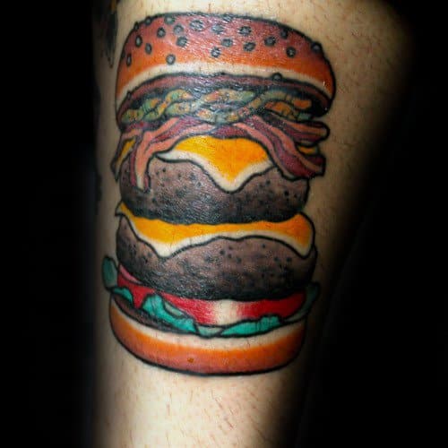 Cheeseburger tattoo design featuring a double patty, bacon, cheese, lettuce, and sesame seed bun