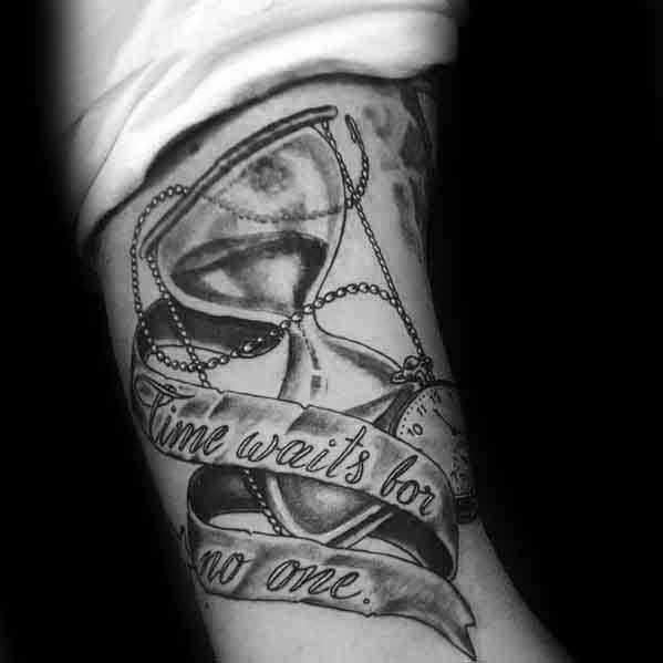 Black and grey tattoo with an hourglass, pocket watch, and flowing banner that reads Time Waits for No One.