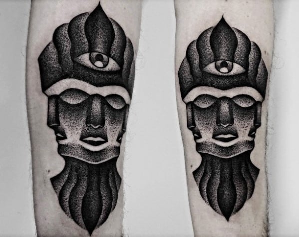 Blackwork Tool-inspired tattoo featuring a stylized, three-faced figure with a central third eye and textured gradient shading throughout.