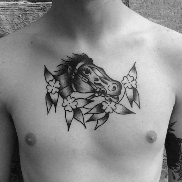 Traditional chest tattoo of a horse head surrounded by leaves and small flowers, done in bold black ink with subtle shading.