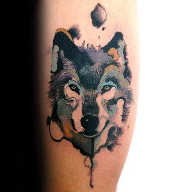 Abstract wolf tattoo with soft watercolor shading, fluid linework, and earthy tones blending into a bold, expressive design.