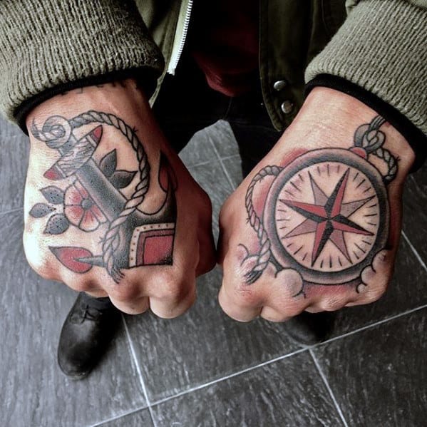 Matching hand tattoos featuring a traditional anchor with rope and a vintage compass, symbolizing direction, stability, and a love for adventure.