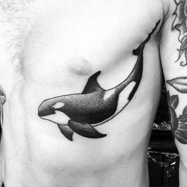 Black and gray orca tattoo on the side, showcasing a smooth, minimalist design with dotwork shading to highlight the whale's graceful form.