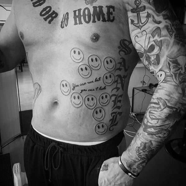 Black and white tattoo design featuring multiple smiley faces, script text "You can run but you can't hide"