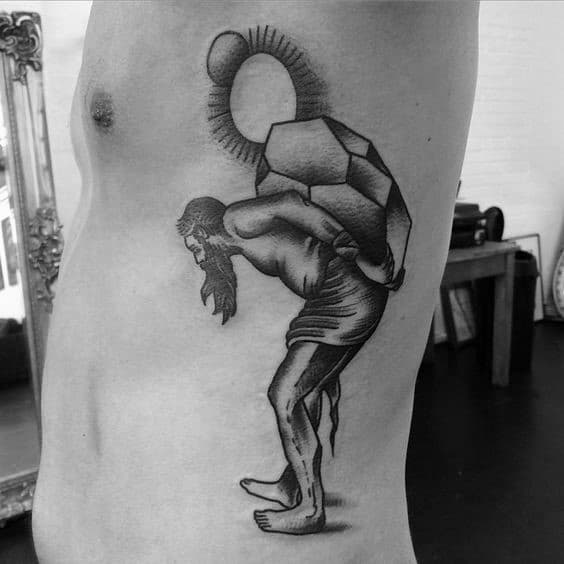 Black and grey Sisyphus rib tattoo with a stylized, weary figure carrying a faceted boulder under a radiant circular sun.