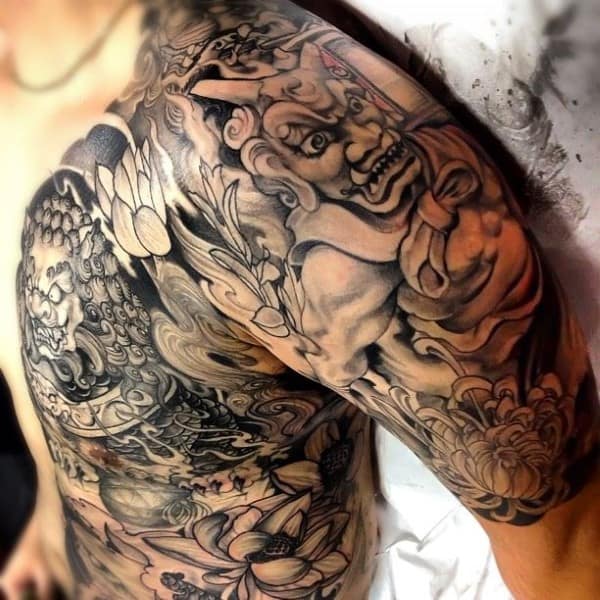 Detailed black and gray Japanese-style tattoo covering chest and right shoulder