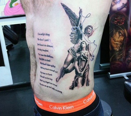 Angel and warrior tattoo with poem on person's left side ribs