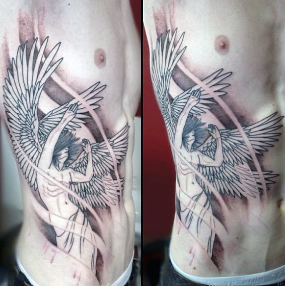 Large winged angel tattoo covers person's chest and side in detailed black and gray ink