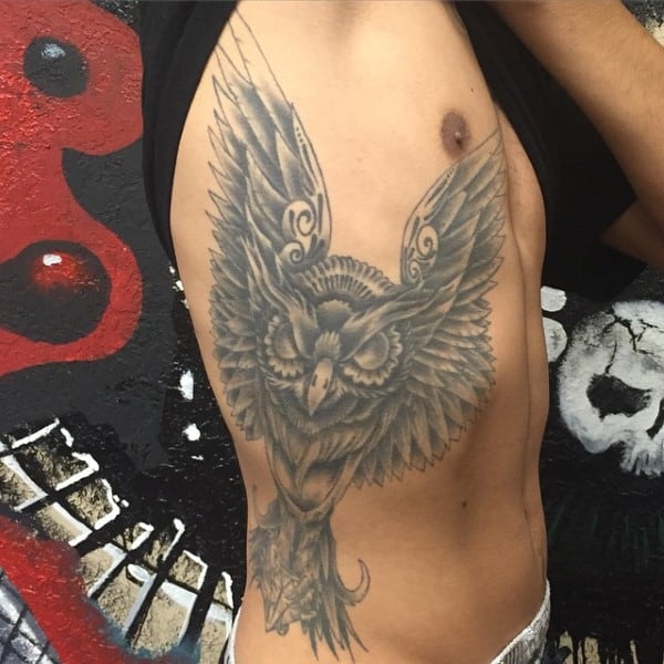 Owl tattoo on a person's side