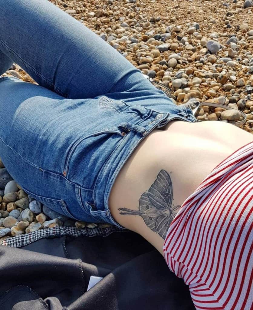 A black and grey Luna Moth tattoo, with intricate wing details