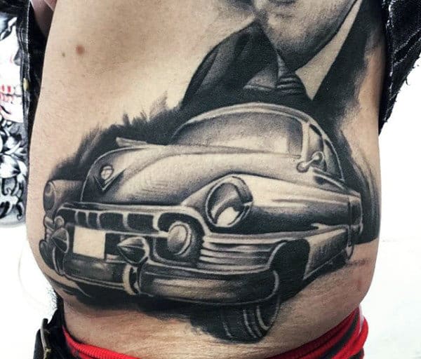 Tattoo of a vintage car with detailed shading on the side torso