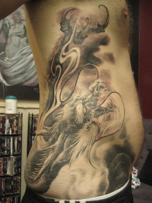 Detailed dragon tattoo on a person's side torso with intricate shading